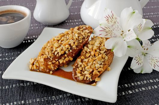 French toast with walnuts and cinnamon and a cup of coffee