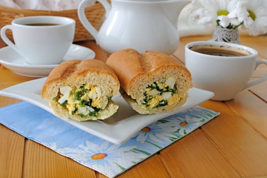 Baguette stuffed with onions and spinach with egg