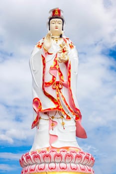 Kuan Yin who is white with blue sky