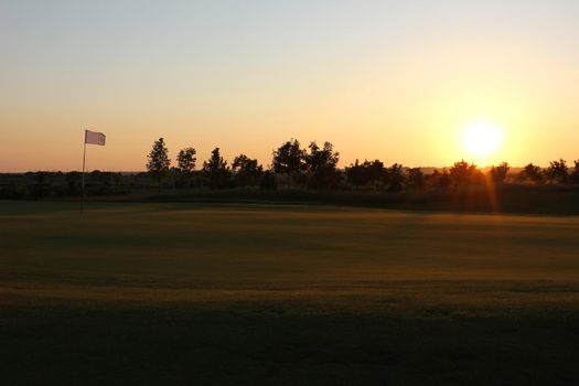 Warm sunset light over golf course.