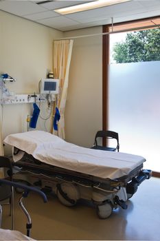 First aid in hospital with bed, monitor and medical equipment
