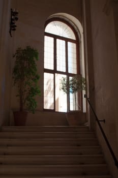 Into the light - old staircase leading to a bright window