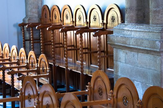 rows of prayers chairs in different heights in a cathedral on Crete Island, Greece