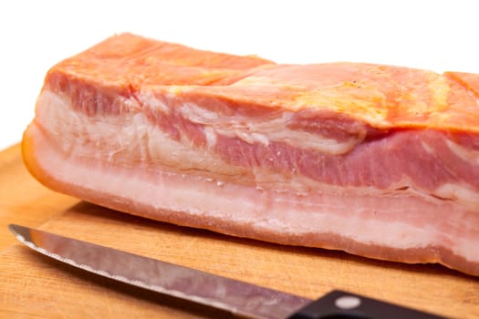 Boiled-Smoked Bacon with knife on cutting board