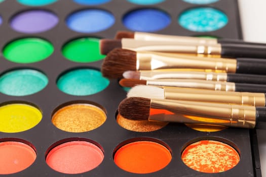 Set of Multicolored Eyeshadows with Brushes, closeup