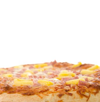 A cooked hawaiian pizza with white copyspace above.
