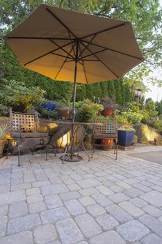 Garden Furniture Table Chairs and Umbrella on Pavers Patio