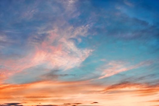 Multicolor clouds at sunset in the fine summer evening