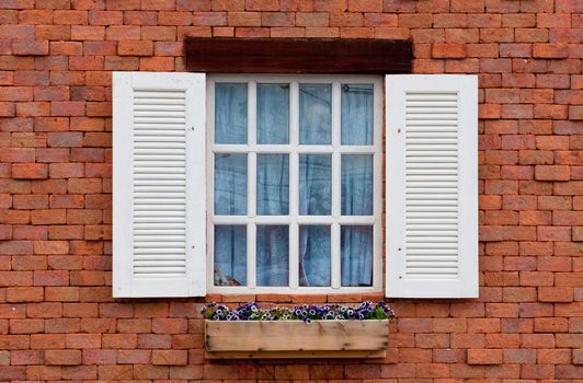 Vintage white window on red brick wall 