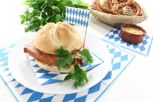 Roll with beef and pork loaf, parsley, Bavarian flag on a light background