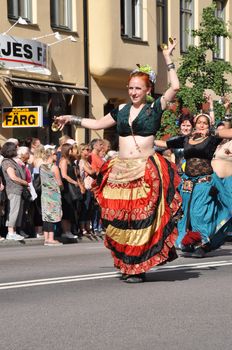 STOCKHOLM, SWEDEN - AUGUST 4: An unidentified woman dancing belly dance in the pride parade on August 4, 2012 in Stockholm. Approximately 50,000 people march the parade and 500,000 bystanders watch the parade.