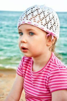 Portrait of cute little girl on the beach