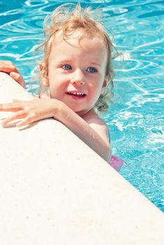 Cute little girl having fun in the swimming pool