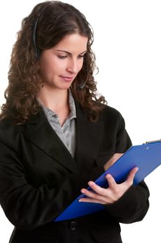 Corporate woman talking over her headset, holding a pad, isolated in a white background