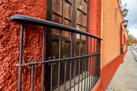 A red colonial style wall and window in San Cristobal de las Casas in Chiapas, Mexico