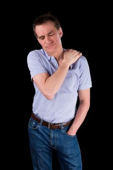 Middle Age Man Holding Shoulder in Pain Black Background