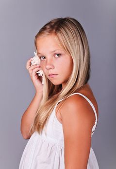 Young girl with shell listening to the sea