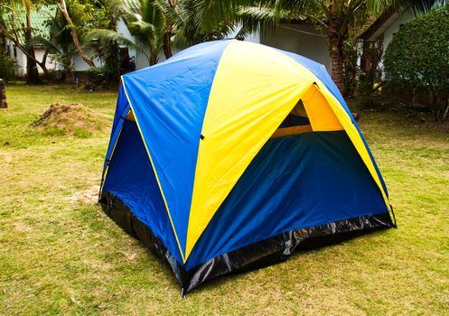 A small canvas tent is placed on the lawn at the resort.