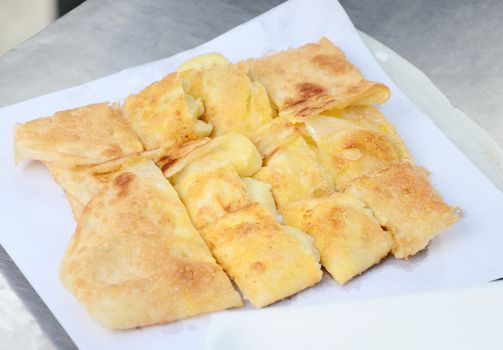 Dessert style of fried Roti with banana cooking on the street in Bangkok, Thailand