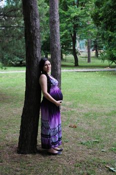 The pregnant girl on walk in city park