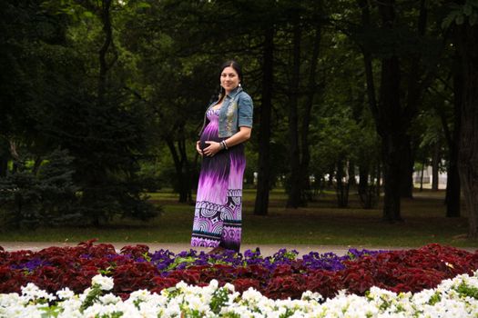 The pregnant girl on walk in city park