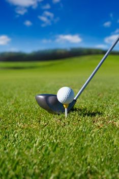 Golf club with ball on tee