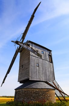 Traditional wooden windmill in France in the Eure &Loir Valley region.This is "moulin Barbier" mill.The image is intentionally deformated a little.