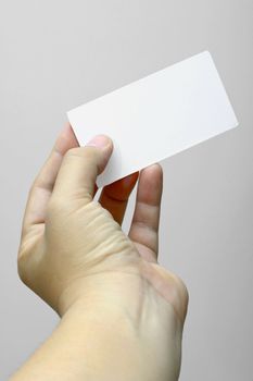 Hand holding and showing a blank business card.