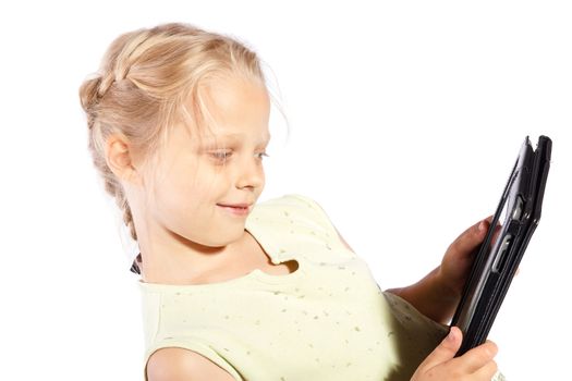 little girl watches movies on their Tablet PC on a white background