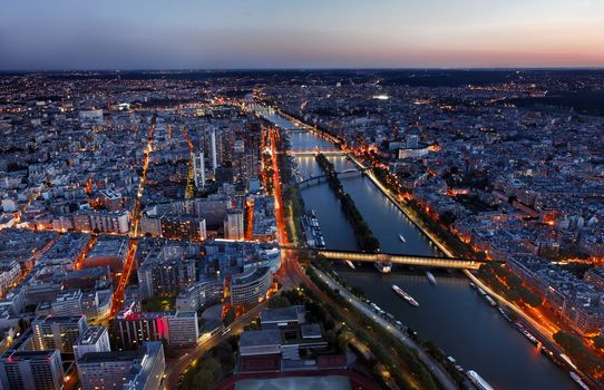 Aerial image of the Seine river and beautiful illuminated quarters in Paris.