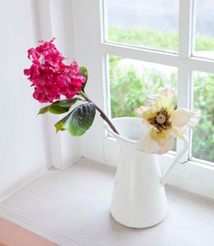 white vase and flower on the white table