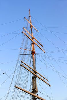 A Ships mast in front of a clear, darkening sky.