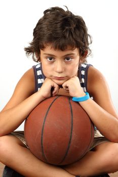 Young cute boy with basketball ball over white