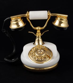 Ancient luxurious telephone with marble and gold isolated