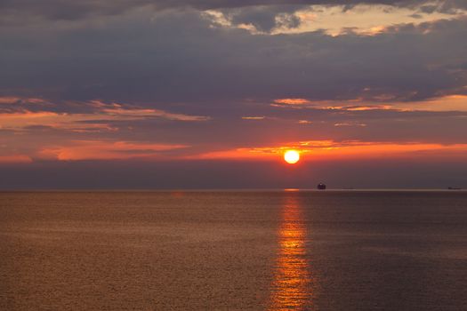 Lonely Ship and Beautiful Sunset near Genoa in Italy