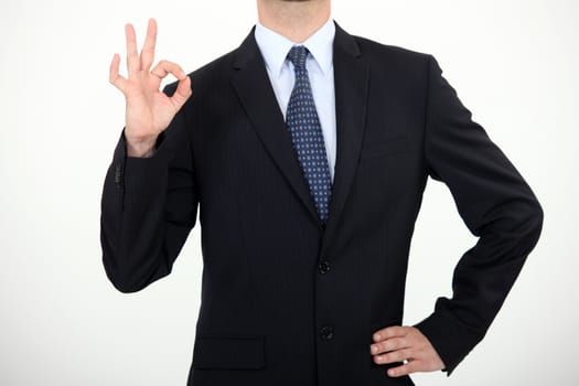 Businessman making thumbs-up gesture