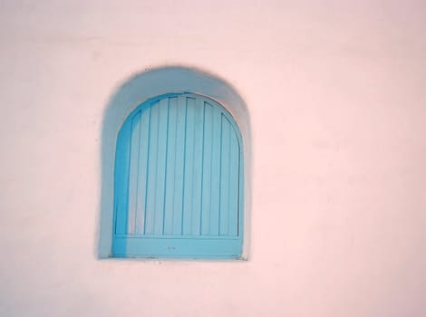 Vintage arch blue windows on the white wall.