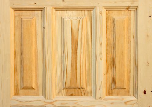 Fragment wooden door made of coniferous tree on white background