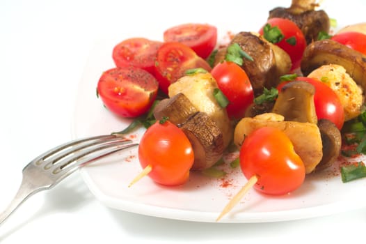 Roasted chicken with mushrooms and tomatoes. Isolated.