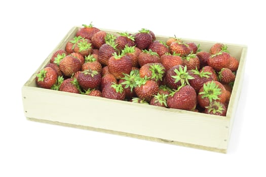 Many ripe strawberry  collected in wooden box