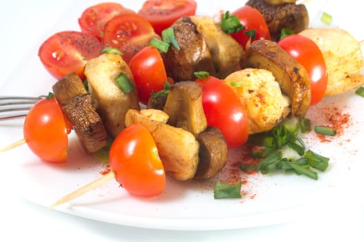 Roasted chicken with mushrooms and tomatoes. Isolated.