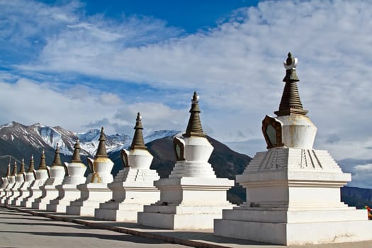 White pagodas Tibet with mountain and blue sky