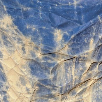 Dirty creased canvas construction debris netting background texture.