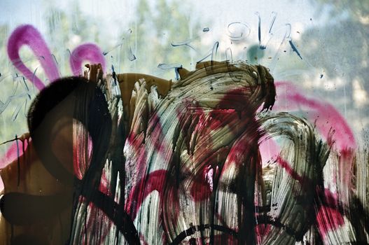 Dusty window glass smudged with dripping paint. Abstract background.