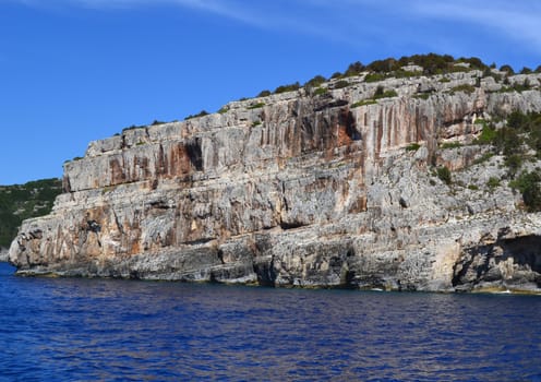 The rocky coast washed by the warm sea