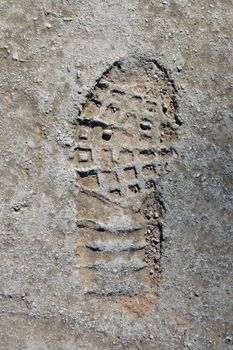 Shoe footprint on concrete surface abstract background.