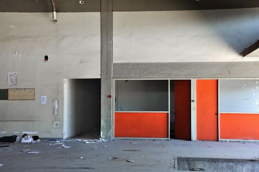 ATHENS, GREECE, SEPTEMBER 2011. Young immigrant sleeps on the dirty floor of an abandoned factory.