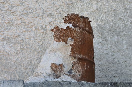 Deteriorated rusty barrel and spilled pile of marble dust powder.