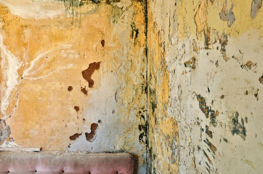 Peeling paint grunge wall in abandoned interior. Background texture.