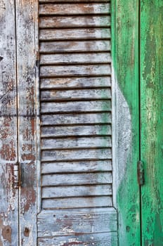 Vintage wooden window shutter with smudged paint background texture.